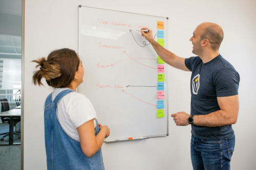 man explaining concept to his female workmate