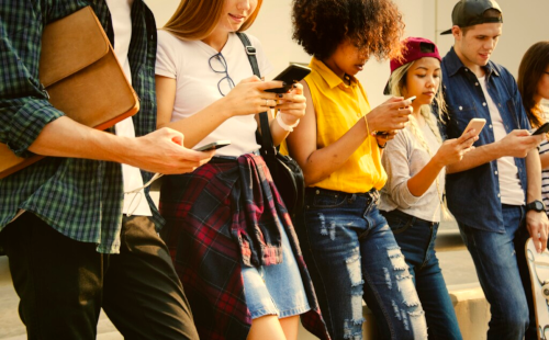 teens using phone together