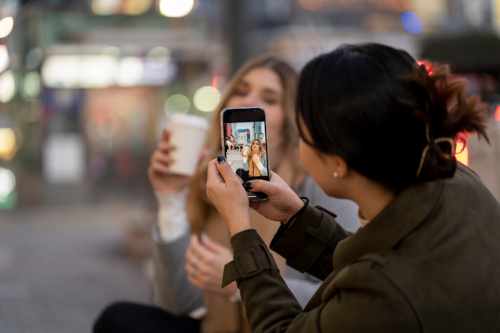 two friends taking photos